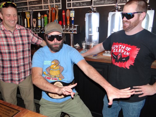Jared, Trevor and Ryan (left to right) celebrate taking home the King of Ohio championship belt at the Ohio Taproom.