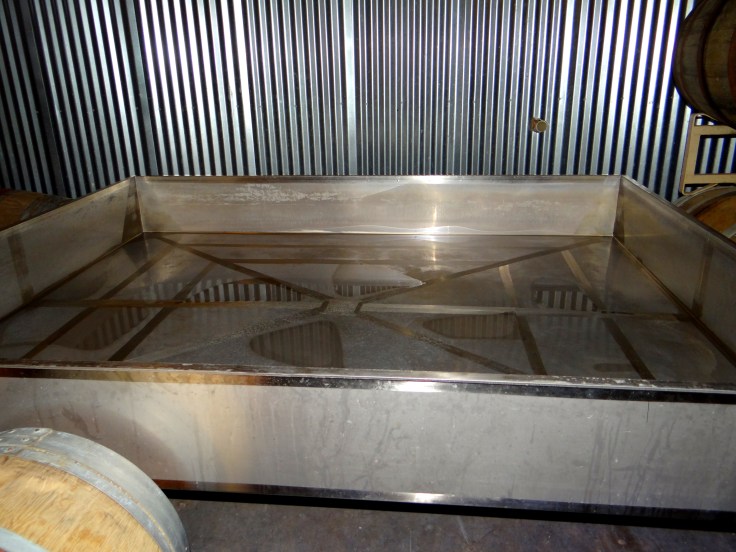 The coolship at de Garde where the wort is exposed to the ambient air while it cools. Notice the nearby wooden barrels that harbor yeast and bacteria that help to properly inoculate the wort.