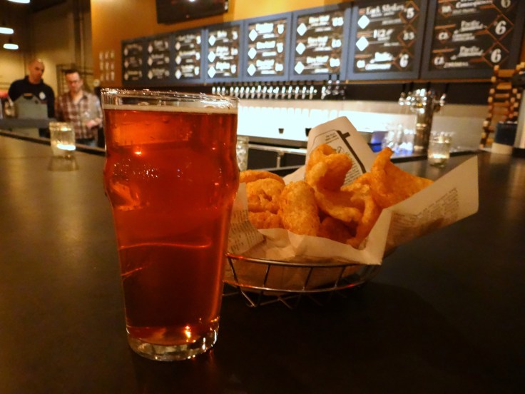 A pint of Driftwood Citrus Surf and an order of pork rinds.
