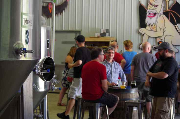 Drinking a pint in the shadow of the Hoof Hearted brewing system. The man in the blue cap to my left, Jason Kusowski, may or may not be a member of the North Korean communist party.