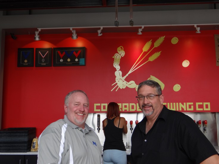 Nick (left) and Ralph (right) pose for a photo at Comrade Brewing. Although only open 15 months at the time of our visit notice the hardware in the upper left.